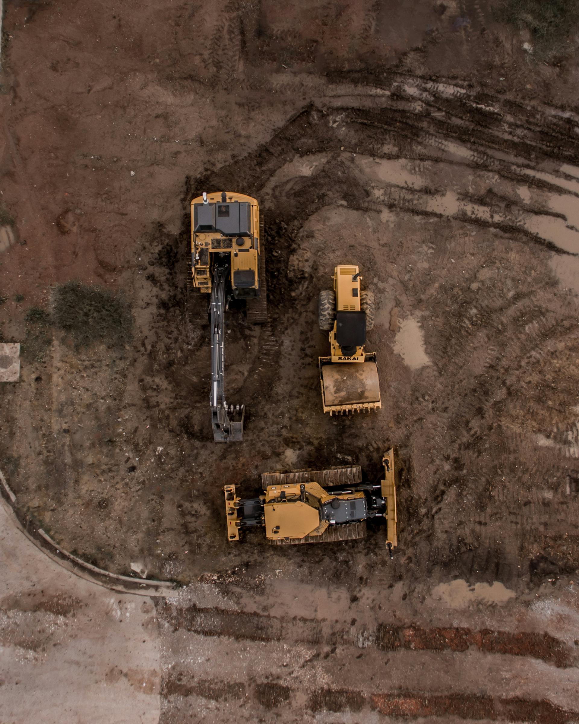 Active underground construction site showing HD Global Group heavy equipment operations from aerial view
